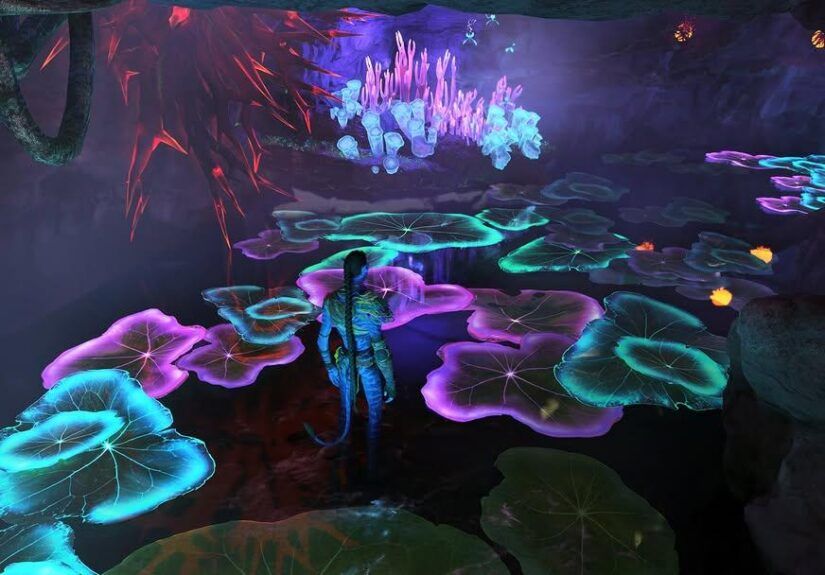 Na'vi character standing in a cave in water at night, so the lilly pads floating are glowing green, blue and purples. While mushrooms are glowing, grass is glowing.